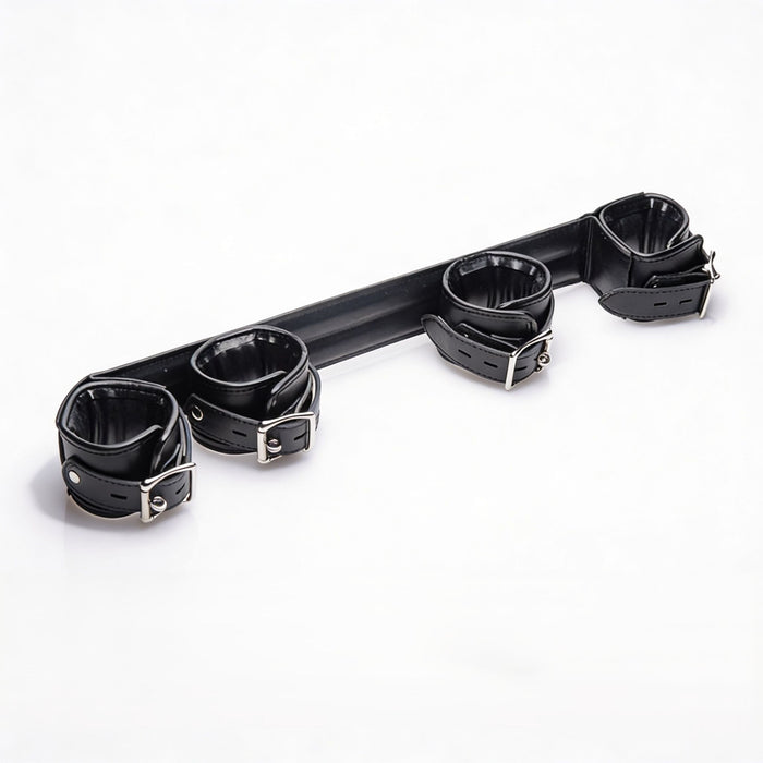 Angled view of the Deluxe Rigid Spreader Bar highlighting the four padded faux leather cuffs, rigid support bar, adjustable straps, and metal buckles
