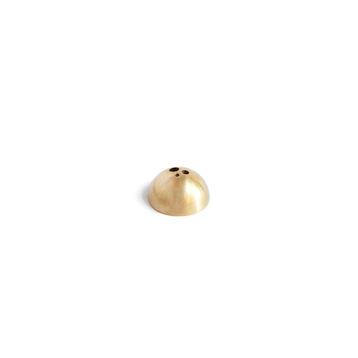 Brass dome incense stick holder with three holes on white background