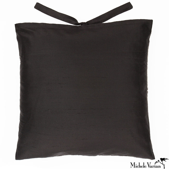 The silk backside of an accent pillow with silk ties.