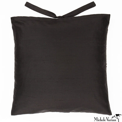 The silk backside of an accent pillow with silk ties.