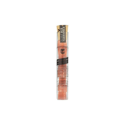 Glass vial of smoked old fashioned sugar cubes on white background