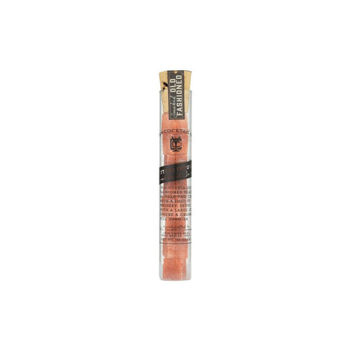 Glass vial of smoked old fashioned sugar cubes on white background