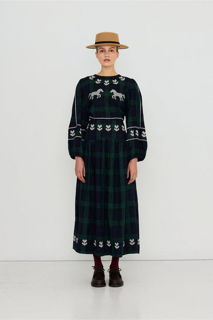 Tiny Big Sister Embroidered Check Skirt AW26-755 on model Shop Tiny Big Sister at Dotique